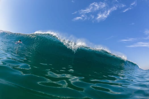 Ocean sea wave vertical crashing hollow tubing water power on shallow beach reefs sandbars, a swimming surfer action water photo