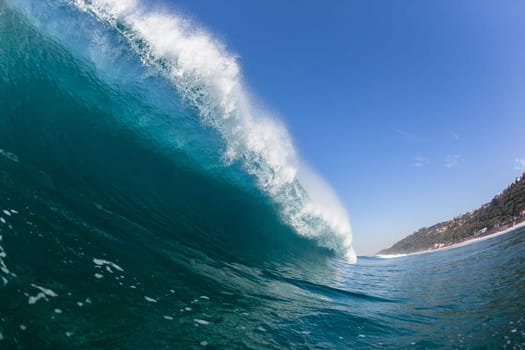 Ocean sea wave vertical crashing hollow tubing water power on shallow beach reefs sandbars, a swimming surfer action water photo