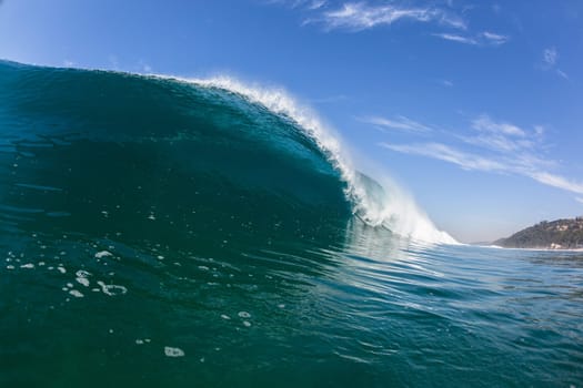 Ocean sea wave vertical crashing hollow tubing water power on shallow beach reefs sandbars, a swimming surfer action water photo