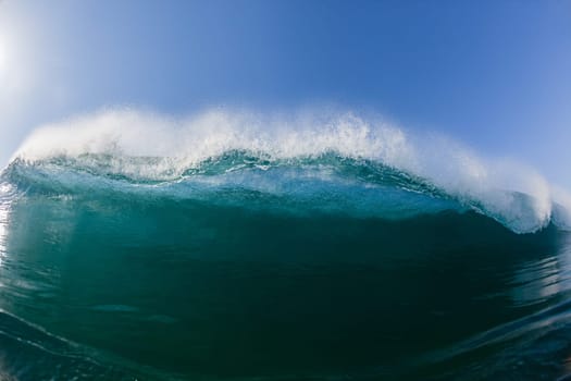 Ocean sea wave vertical crashing hollow tubing water power on shallow beach reefs sandbars, a swimming surfer action water photo