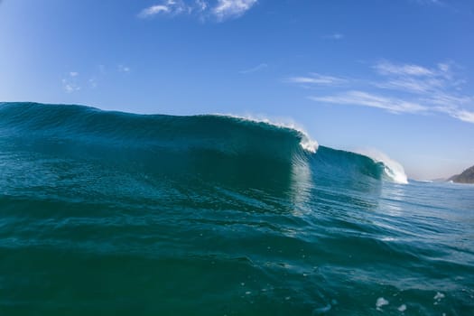 Ocean sea wave vertical crashing hollow tubing water power on shallow beach reefs sandbars, a swimming surfer action water photo