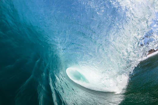Ocean sea wave vertical crashing hollow tubing water power on shallow beach reefs sandbars, a swimming surfer action water photo