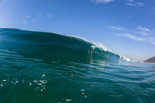 Ocean sea wave vertical crashing hollow tubing water power on shallow beach reefs sandbars, swimming water photo