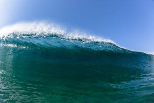 Ocean sea wave vertical crashing hollow tubing water power on shallow beach reefs sandbars, a swimming surfer action water photo