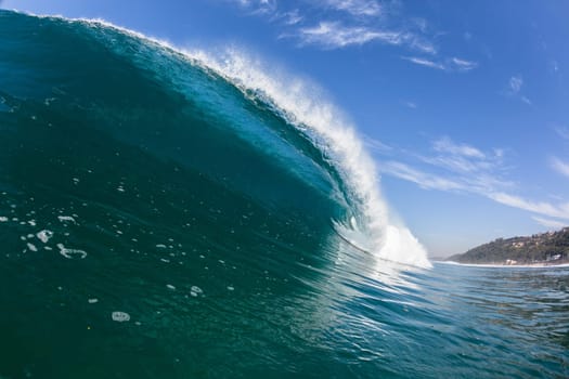 Ocean sea wave vertical crashing hollow tubing water power on shallow beach reefs sandbars, a swimming surfer action water photo