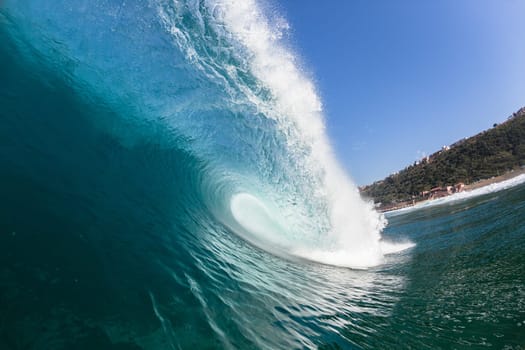 Ocean sea wave vertical crashing hollow tubing water power on shallow beach reefs sandbars, a swimming surfer action water photo