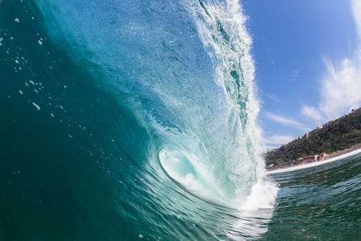 Ocean sea wave vertical crashing hollow tubing water power on shallow beach reefs sandbars, a swimming surfer action water photo