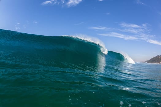 Ocean sea wave vertical crashing hollow tubing water power on shallow beach reefs sandbars, a swimming surfer action water photo
