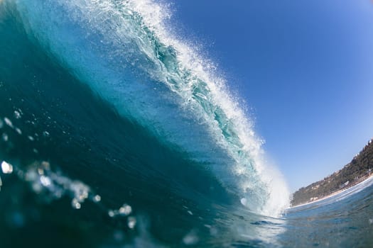 Ocean sea wave vertical crashing hollow tubing water power on shallow beach reefs sandbars, a swimming surfer action water photo