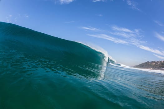 Ocean sea wave vertical crashing hollow tubing water power on shallow beach reefs sandbars, a swimming surfer action water photo