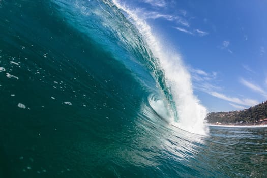 Ocean sea wave vertical crashing hollow tubing water power on shallow beach reefs sandbars, a swimming surfer action water photo