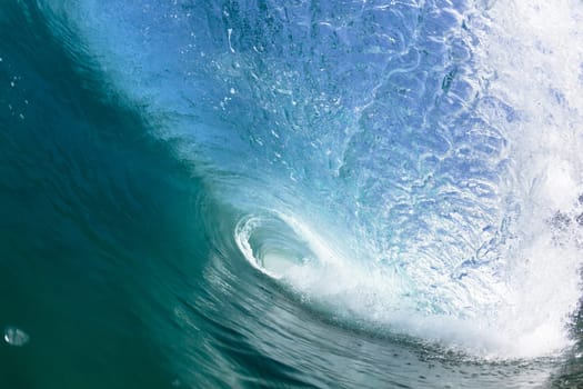 Ocean sea wave vertical crashing hollow tubing water power on shallow beach reefs sandbars, a swimming surfer action water photo