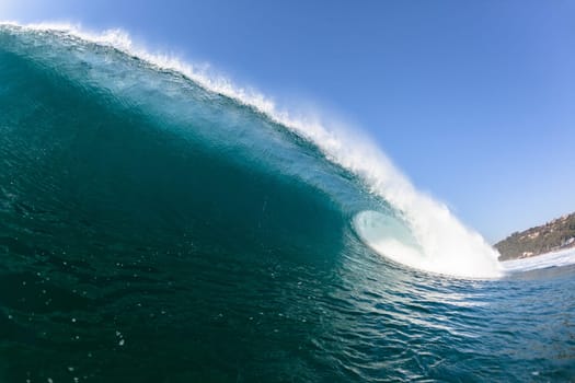 Ocean sea wave vertical crashing hollow tubing water power on shallow beach reefs sandbars, a swimming surfer action water photo