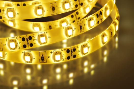 Macrodetail of a warm white LED strip in coloured light