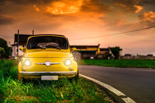 Small vintage italian car Fiat Abarth. Yellow color