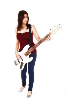 A young woman standing in the studio, playing her guitar, isolated on white.background..