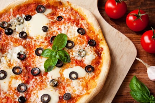 Pizza with olives and basil