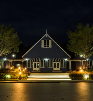 Stunning view of Dutch style house illuminated at night