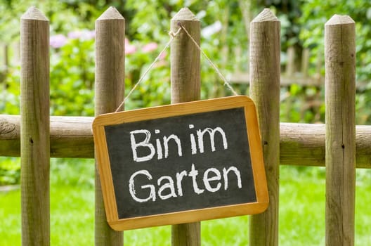 Chalkboard with the inscription Bin in the garden