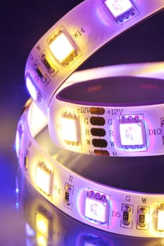 Macrodetail of an RGB LED strip combined with warm white LEDs in colored light