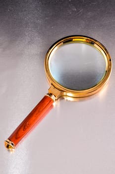 Vintage Magnify Glass Loupe on a Colored Background