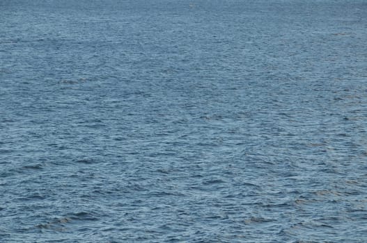 Blue Still Sea Water With Ripple. Natural Background Photo Texture