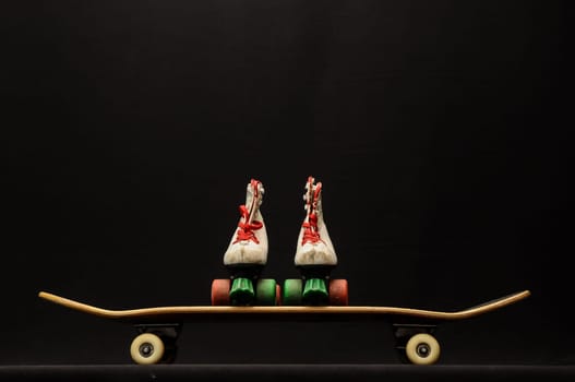 Vintage Style Black Skateboard and Skate Boot on a Dark Background