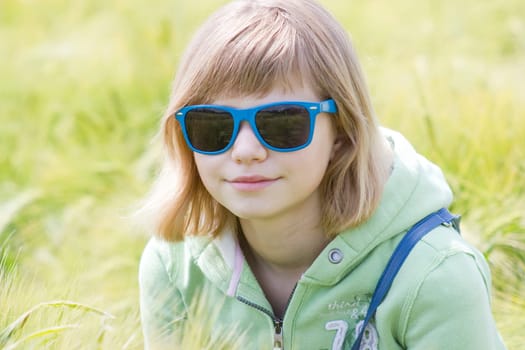 portrait of a little girl in the field of barley