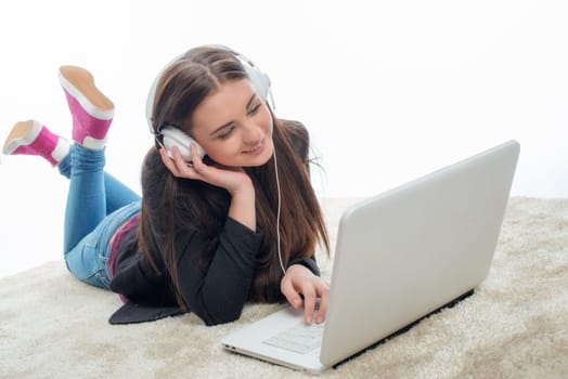 Young girl with laptop and headphones