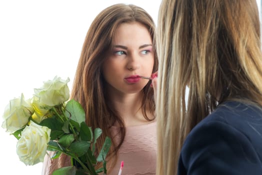 Make-up woman makes up a girl