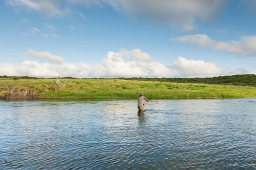 Man fishing for salmon in a beautiful surrounding