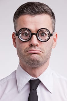 an upset and disappointed nerd clerk staring at camera very unhappy