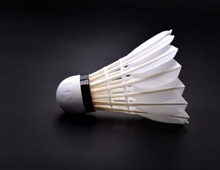 new shuttlecock on dark floor