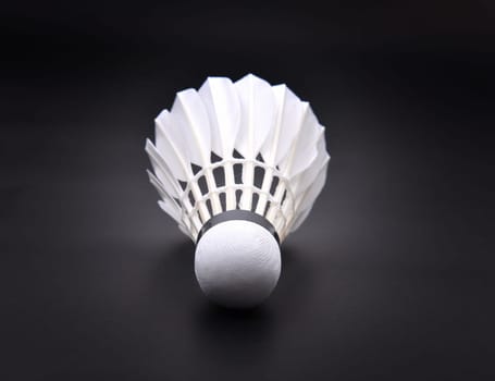 new shuttlecock on dark floor