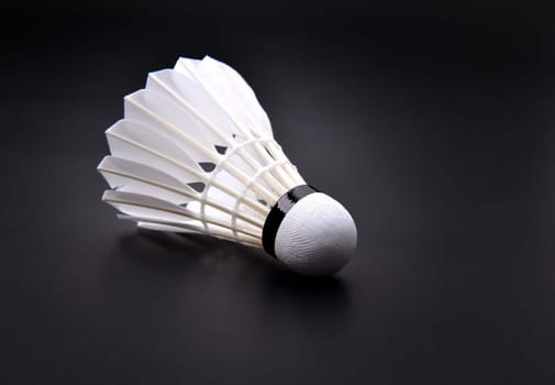 new shuttlecock on dark floor