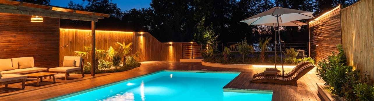 Serene backyard pool with lounge area and soft evening lighting