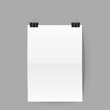 White paper folded in half hands on black clips on grey background