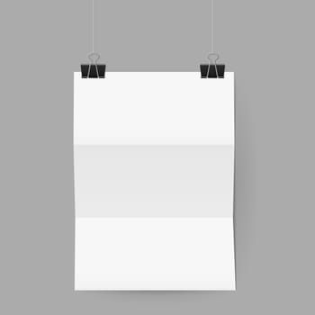 White sheet of paper folded in three. The paper hangs on black binder clips.
