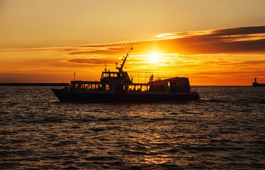 Sailng boat at open sea at sunset