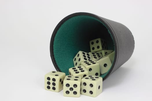 White dice with black and green dice cup - isolated