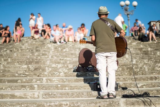 Street musician singing in front of a crowd