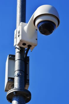 Hi-tech dome type camera over blue sky