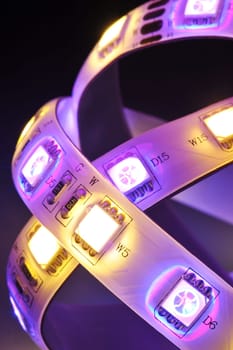 Macrodetail of an RGB LED strip combined with warm white LEDs in colored light