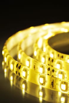 Macrodetail of a warm white LED strip in coloured light