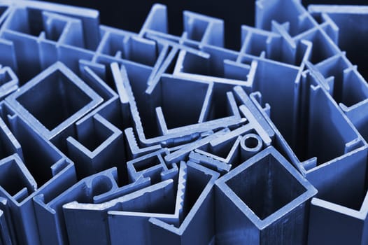 many different aluminium profile strips in blue spotlight