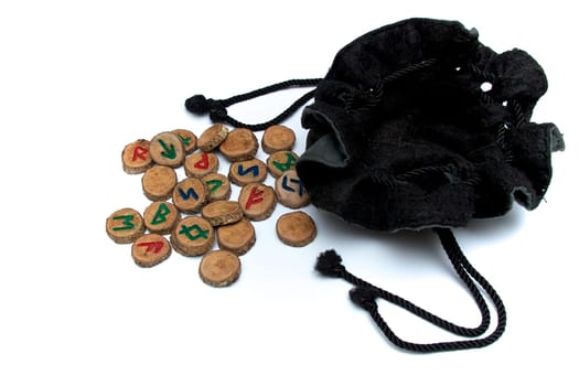 Set of oak runes, an ancient alphabet known as the futhark on white with draw string pouch..Note