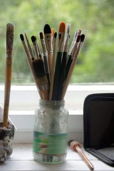 The photography of brushes and painting utensils of an artist.