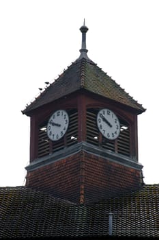 The photograph of a clock tower of a disused hospital.