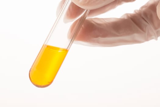 Orange liquid in test tube ready for analysis.