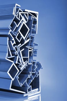 many different aluminium profile strips in blue spotlight